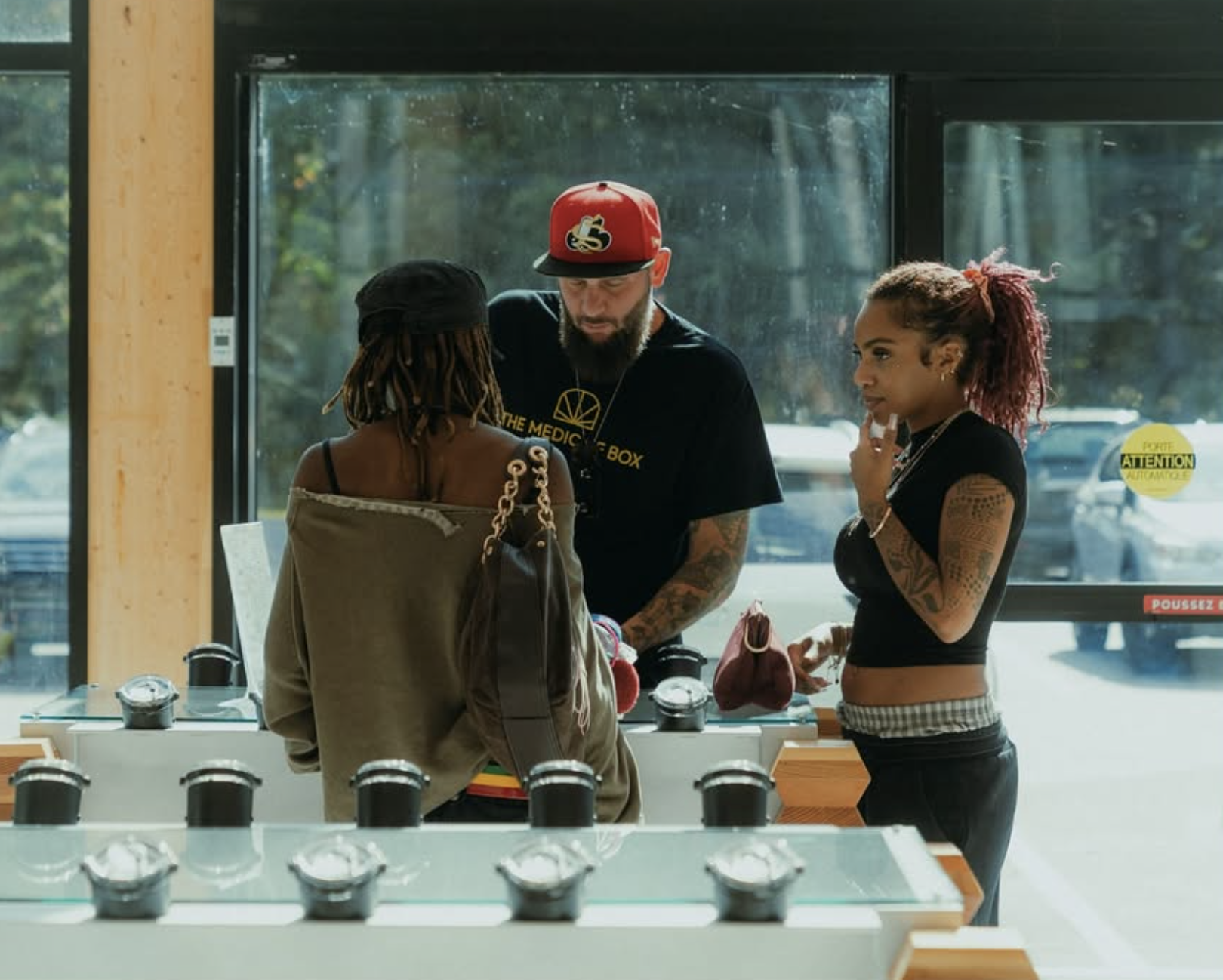 Team member assisting customers at The Medicine Box counter